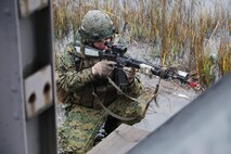 A combat engineer with 8th Engineer Support Battalion, 2nd Marine Logistics Group provides cover at the base of a bridge during the unit’s dismounted patrol training aboard Camp Lejeune, N.C., Dec. 13, 2012. The Marines got into a firefight with a rival platoon during a reconnaissance of the bridge the previous night.