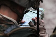 Cpl. Damon R. Ortega, a combat engineer with 8th Engineer Support Battalion, 2nd Marine Logistics Group, plots a route to his platoon’s next objective during a training operation aboard Camp Lejeune, N.C., Dec. 13, 2012. Ortega served as a team leader during the patrol, which ended in an ambush of a rival platoon. 