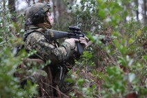 A combat engineer with 8th Engineer Support Battalion, 2nd Marine Logistic Group provides perimeter security during a training operation aboard Camp Lejeune, N.C., Dec. 13, 2012. The Marines conducted three days of patrols, simulated ambushes and resupply missions, which forced rival platoons to engage in firefights as they battled to complete opposing objectives. 