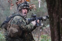 Cpl. Damon R. Ortega, a combat engineer with 8th Engineer Support Battalion, 2nd Marine Logistics Group, calls for support during a firefight with another platoon of Marines at the unit’s training site aboard Camp Lejeune, N.C., Dec. 13, 2012. Ortega served as the team leader for his platoon and laid an ambush for rival Marines just prior to the firefight.