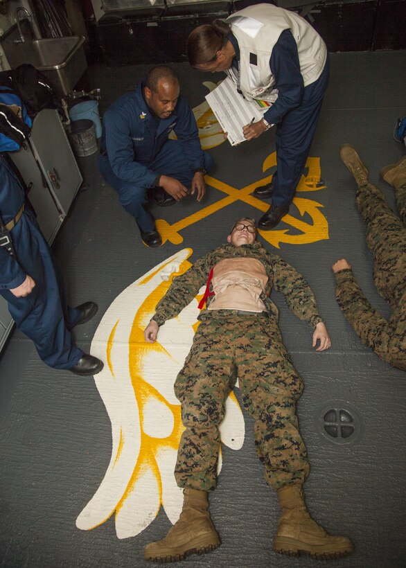 Sailors assigned to USS Bataan (LHD 5) perform triage on Marines assigned to 26th Marine Expeditionary Unit (MEU) during a mass casualty exercise aboard the USS Bataan off the coast of North Carolina, Dec. 14, 2012. The exercise was conducted to familiarize Marines and Sailors on proper techniques of triaging in a deployed environment. The 26th MEU operates continuously across the globe, providing the president and unified combatant commanders with a forward-deployed, sea-based quick reaction force. The MEU is a Marine Air-Ground Task Force capable of conducting amphibious operations, crisis response, and limited contingency operations. They are slated to deploy in 2013. (U.S. Marine Corps photo by Cpl. Christopher Stone/Released)