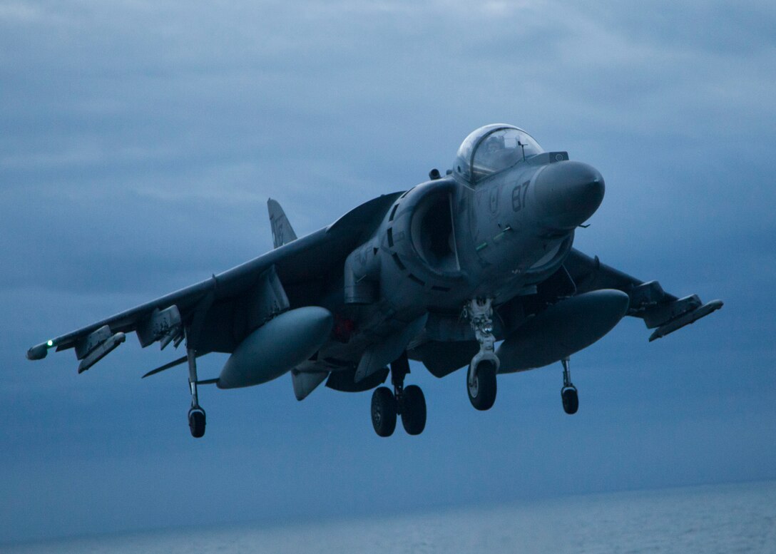 An AV-8B Harrier assigned to Marine Medium Tiltrotor Squadron (VMM) 266 Reinforced, 26th Marine Expeditionary Unit (MEU), flies over the Atlantic Ocean to the USS Bataan (LHD 5) off the coast of North Carolina, Dec. 15, 2012. The touch and go landings were a part of the unit's qualifications required for deployment. The 26th MEU operates continuously across the globe, providing the president and unified combatant commanders with a forward-deployed, sea-based quick reaction force. The MEU is a Marine Air-Ground Task Force capable of conducting amphibious operations, crisis response, and limited contingency operations. The 26th MEU is slated to deploy in 2013. (U.S. Marine Corps photo by Cpl. Christopher Stone/Released)