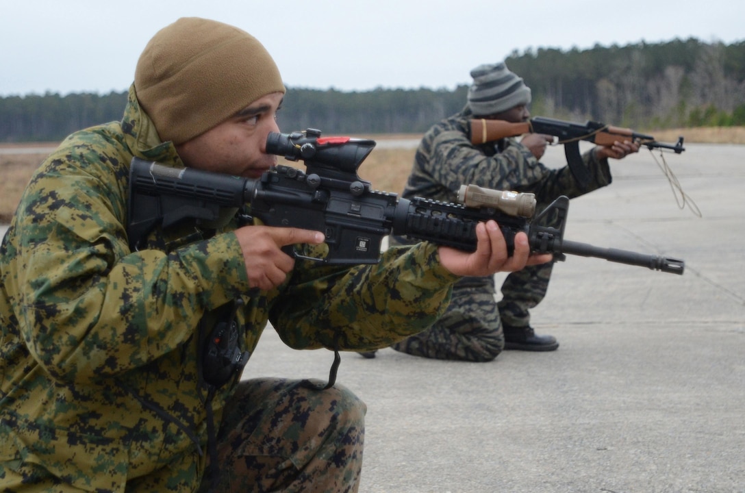 Sgt. Miguel Diaz, a Special-Purpose Marine Air-Ground Task Force Africa combat engineer, practices patrolling with a role player portraying a soldier of an African partner nation during the unit's mission rehearsal exercise aboard Marine Corps Base Camp Lejeune, N.C., Dec. 12, 2012. The four-day exercise simulated situations the Marines and sailors may encounter during their deployment, such as language barriers, requests for supplies and local illnesses. (Marine Corps photo by Sgt. Austin Hazard/Released)