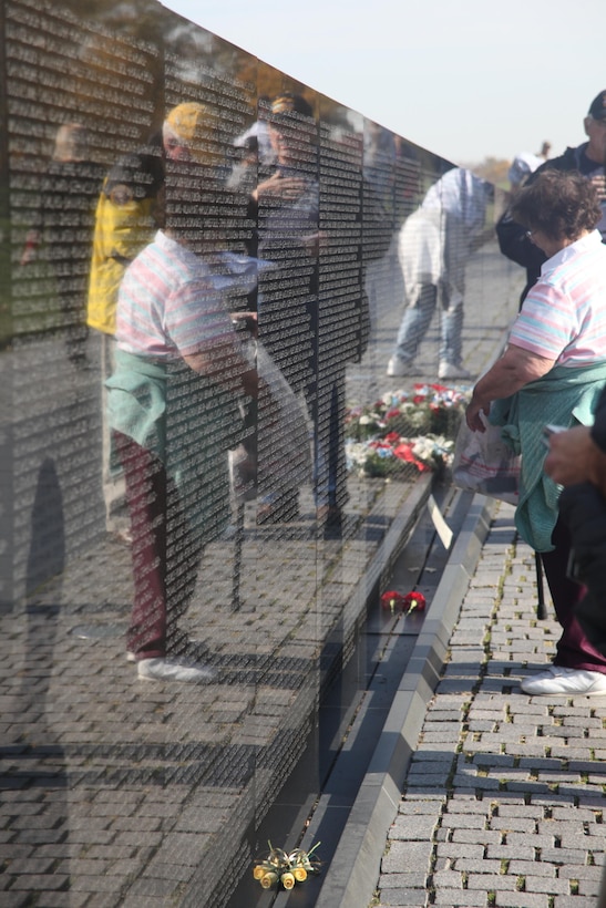 Two veterans of the Vietnam War speak with a visitor to the Vietnam Memorial in Washington D.C. Nov. 10. Veterans, family members, and other servicemembers spent three days reading the names of every servicemember whose name is on the wall in remembrance of the sacrifices they made.