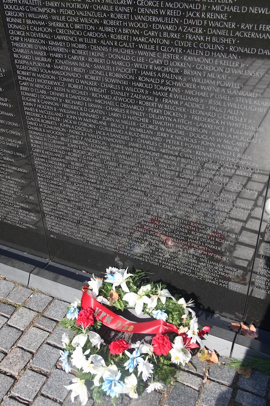 Visitors leave flags, letters and other mementos at the foot of the Vietnam Memorial in Washington D.C. Nov. 10. After so long the mementos are taken and placed in a museum that houses all the things left at the wall.