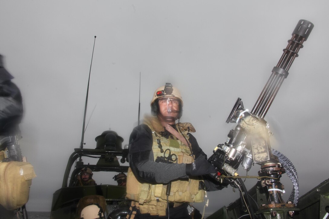 Petty Officer 1st Class Michael Pearson, a gunner with Navy Riverine Squadron 2, keeps watch over the water behind a Mark 44 mini-gun on a riverine vessel Dec. 12. The Sailors conducted training to prepare for an upcoming deployment to South America.