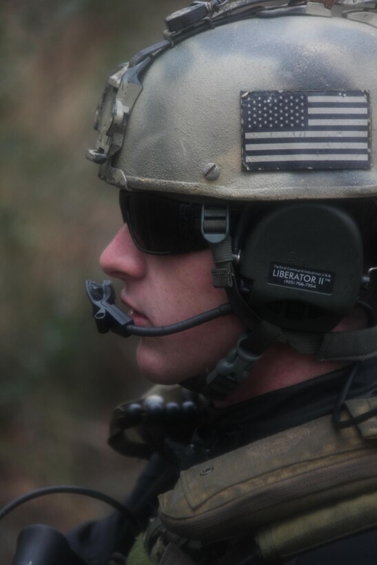 Petty Officer 2nd Class Neil Gahimer, a gunner with Navy Riverine Squadron 2, radios for extraction after his team recovered a simulated weapons cache in the Cherry Point area Dec. 12.