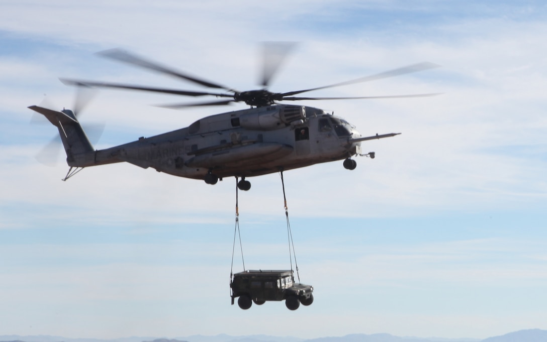 A CH-53E Super Stallion with Marine Heavy Helicopter Squadron 466, 3rd Marine Aircraft Wing, carries a humvee during an external lift exercise aboard Marine Corps Air Ground Combat Center Twentynine Palms, Calif., Dec. 5. Super Stallions commonly carry loads that cannot fit into the cargo hold to transport to different locations quickly.