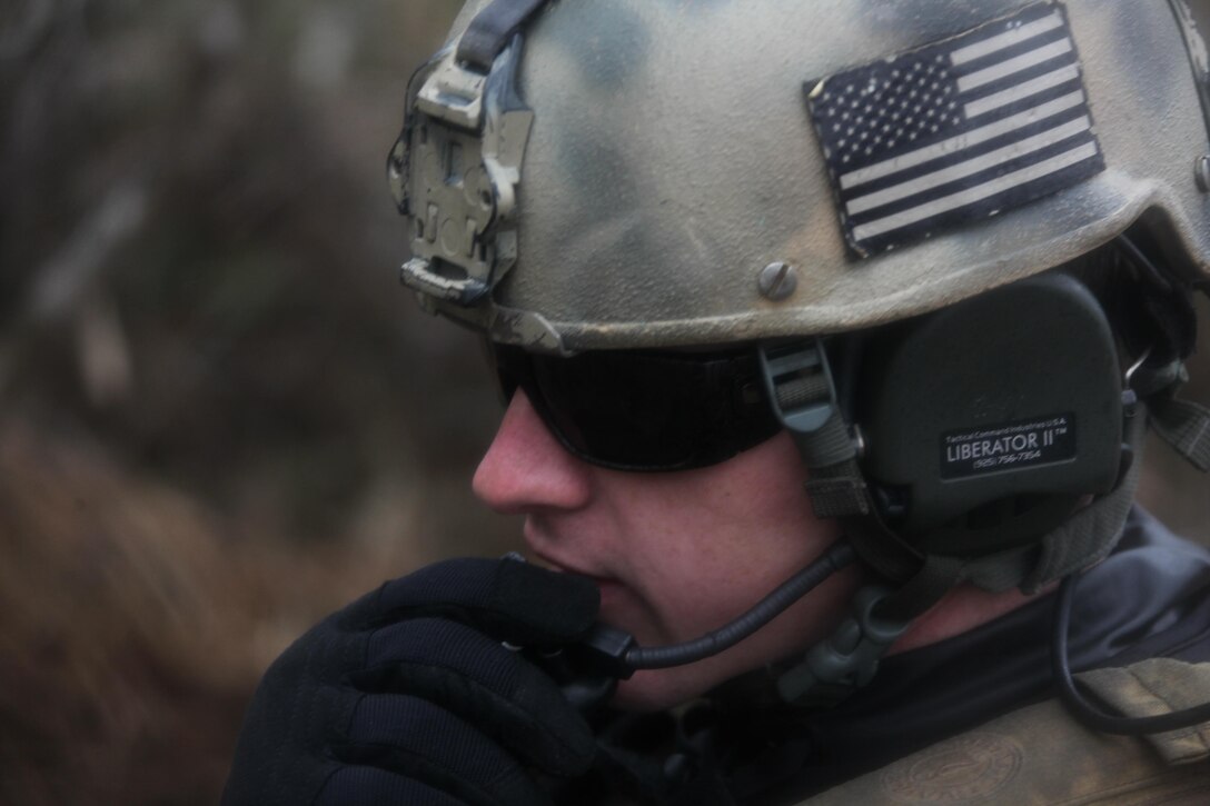 Petty Officer 2nd Class Neil Gahimer, a gunner with Navy Riverine Squadron 2, radios for extraction after his team recovered a simulated weapons cache in the Cherry Point area Dec. 12.