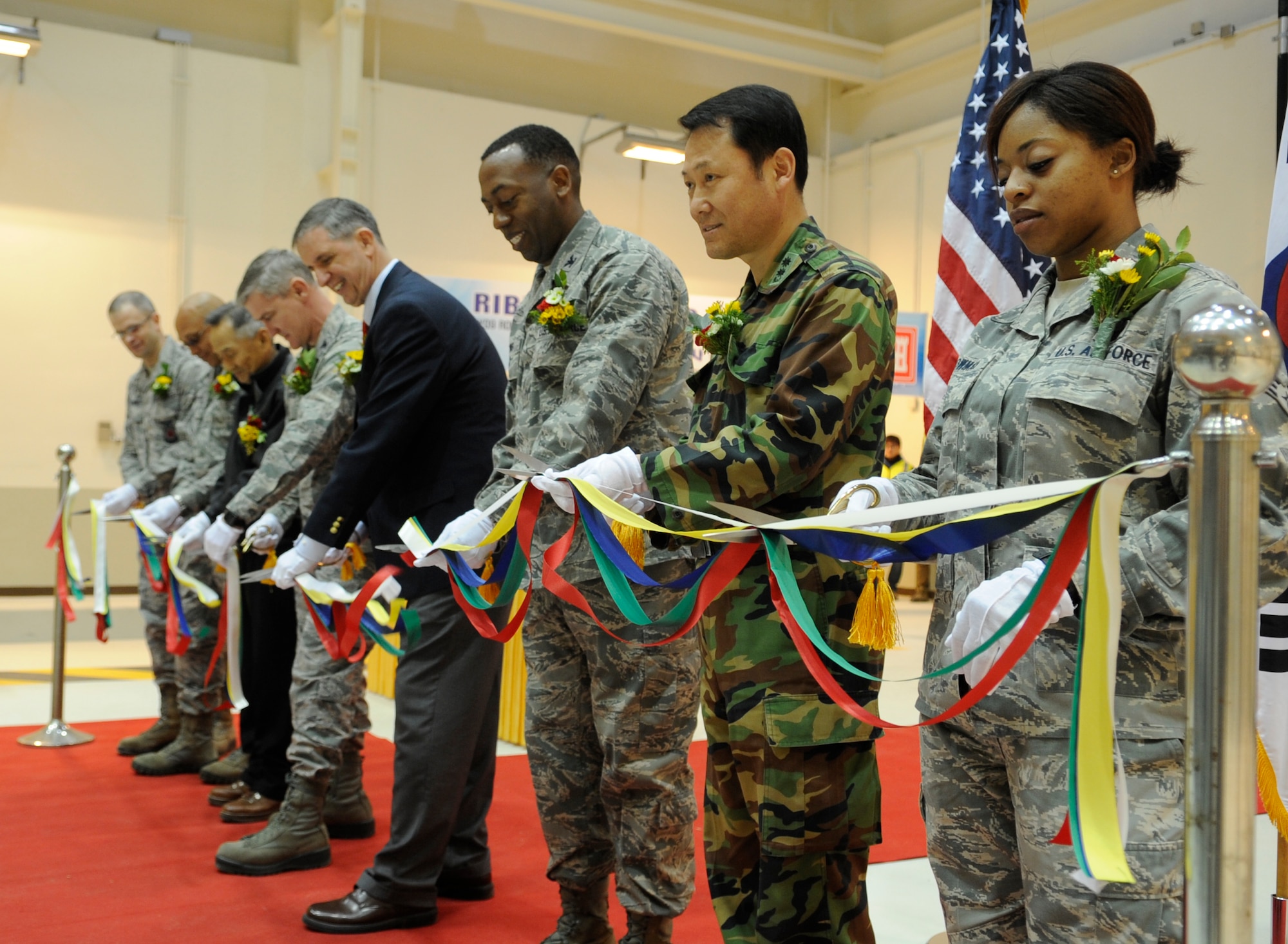 U.S. and Republic of Korea airmen and contractors participate in a ribbon-cutting ceremony for the new 8th Maintenance Squadron accessory shop Dec. 18, 2012, at Kunsan Air Base, Republic of Korea. The $8 million project consolidated 18 interrelated maintenance shops from across the base into a single area. (U.S. Air Force photo by Senior Airman Brigitte N. Brantley/Released)
