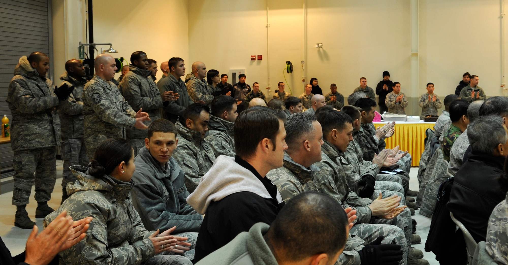 Audience members applaud during a ribbon-cutting ceremony for the new 8th Maintenance Squadron accessory shop Dec. 18, 2012, at Kunsan Air Base, Republic of Korea. The older facilities covered three square miles; this new facility will increase the squadron’s efficiency in transporting parts between shops. (U.S. Air Force photo by Senior Airman Brigitte N. Brantley/Released)