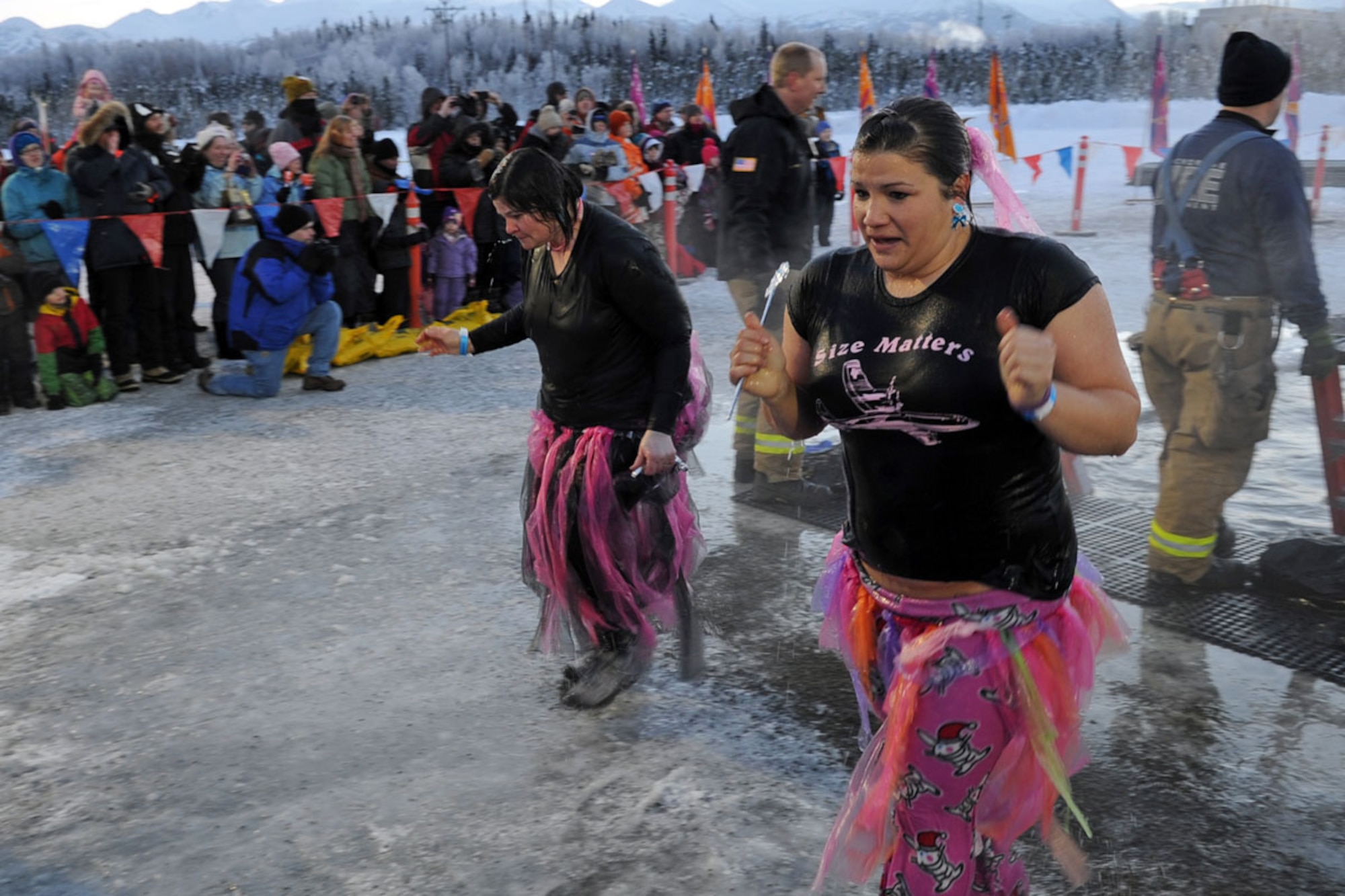 Spouses from the 537th Airlift Squadron, Joint Base Elmendorf-Richardson, participate in Polar Plunge 2012, Dec. 15. The Polar Plunge supports Special Olympics Alaska athletes by gathering pledges and jumping or running into the icy waters of Goose Lake in Anchorage, Alaska. So far the event has raises more than $377,000. (U.S. Air Force photo/Tech Sgt. Brian Ferguson)