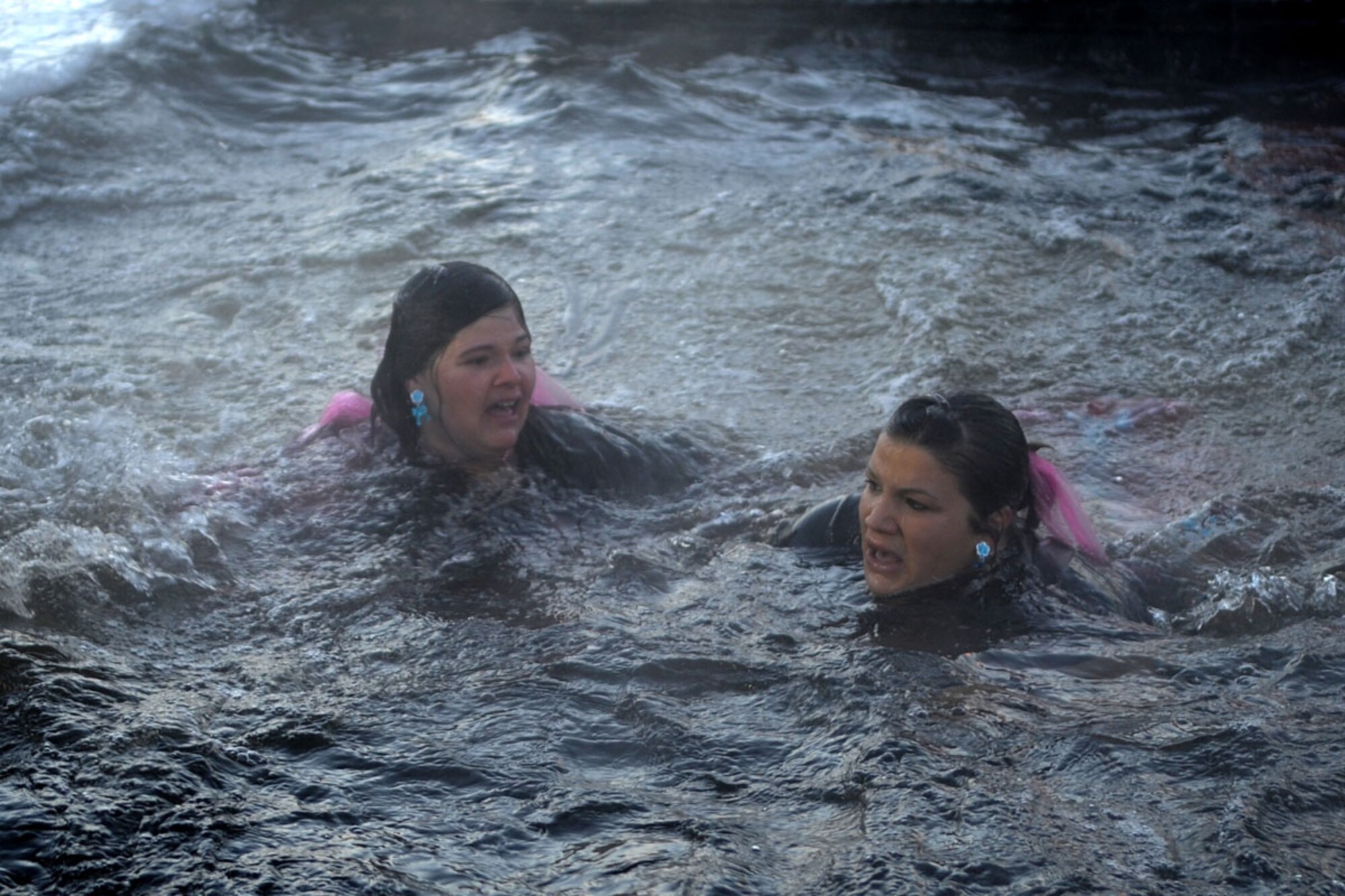 Spouses from the 537th Airlift Squadron, Joint Base Elmendorf-Richardson, participate in Polar Plunge 2012, Dec. 15. The Polar Plunge supports Special Olympics Alaska athletes by gathering pledges and jumping or running into the icy waters of Goose Lake in Anchorage, Alaska. So far the event has raises more than $377,000. (U.S. Air Force photo/Tech Sgt. Brian Ferguson)
