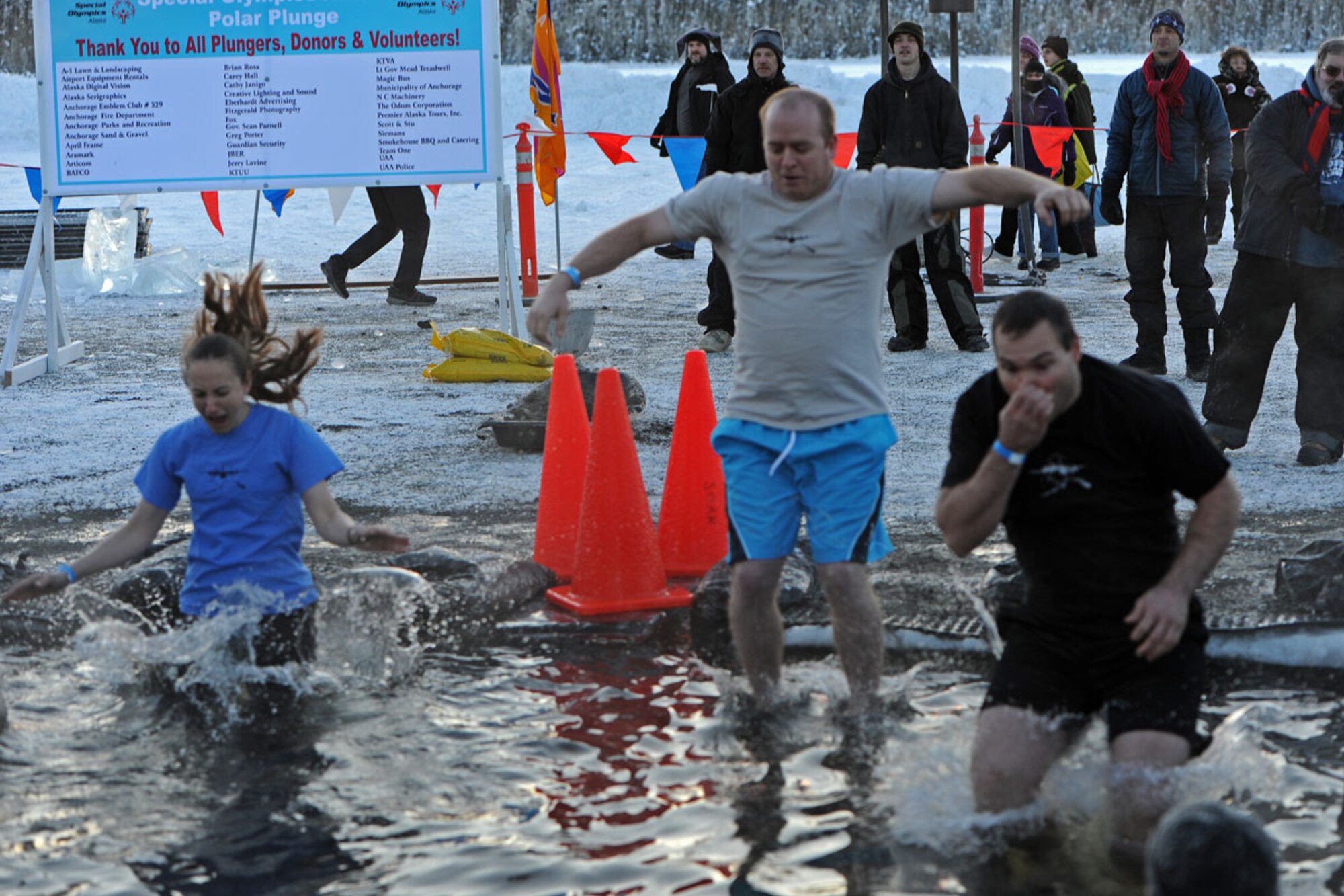 Members of the 537th Airlift Squadron, Joint Base Elmendorf-Richardson, participate in Polar Plunge 2012, Dec. 15. The Polar Plunge supports Special Olympics Alaska athletes by gathering pledges and jumping or running into the icy waters of Goose Lake in Anchorage, Alaska. So far the event has raises more than $377,000. (U.S. Air Force photo/Tech Sgt. Brian Ferguson)
