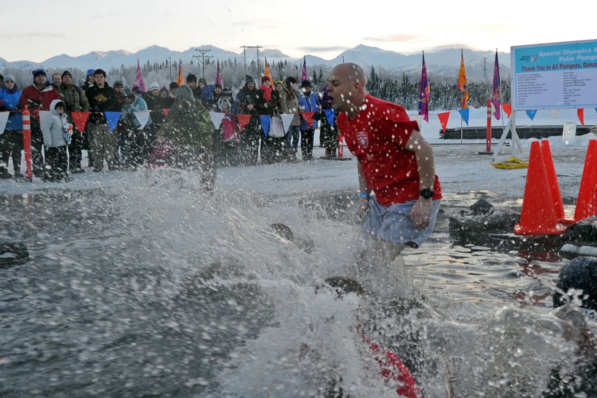 Members of the Joint Base Elmendorf-Richardson Fire Department participate in Polar Plunge 2012, Dec. 15. The Polar Plunge supports Special Olympics Alaska athletes by gathering pledges and jumping or running into the icy waters of Goose Lake in Anchorage, Alaska. So far the event has raises more than $377,000. (U.S. Air Force photo/Tech Sgt. Brian Ferguson)