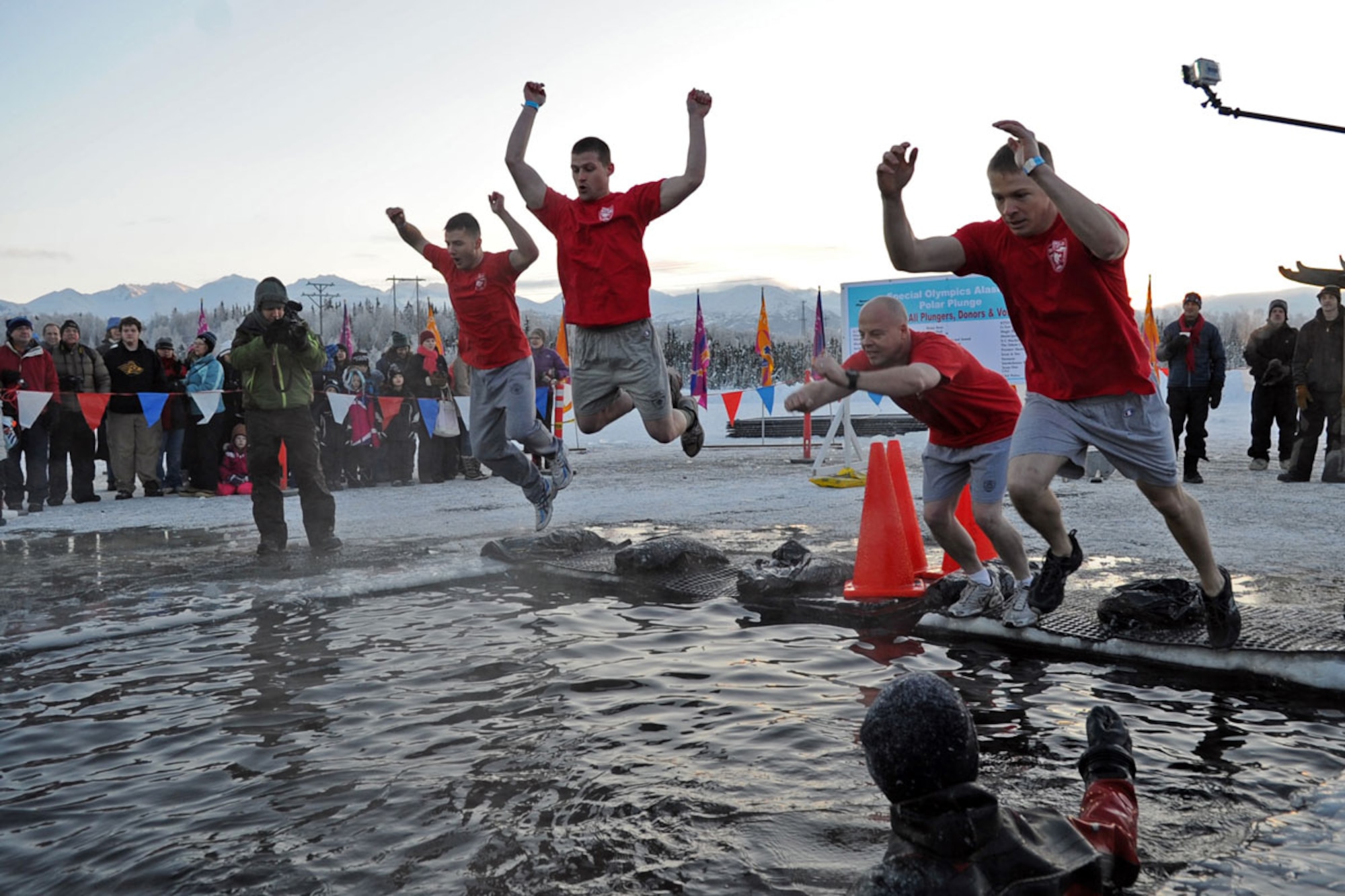 Members of the Joint Base Elmendorf-Richardson Fire Department participate in Polar Plunge 2012, Dec. 15. The Polar Plunge supports Special Olympics Alaska athletes by gathering pledges and jumping or running into the icy waters of Goose Lake in Anchorage, Alaska. So far the event has raises more than $377,000. (U.S. Air Force photo/Tech Sgt. Brian Ferguson)