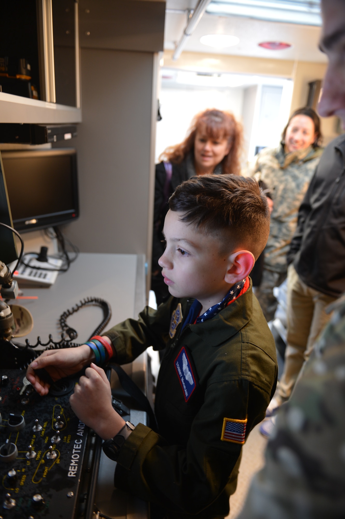 Tommy McGraw controls an explosive ordnance disposal robot from inside the EOD's Off-base/On-base Response Vehicle (BESRV) Dec. 17, 2012 at Joint Base Lewis-McChord, Wash. Tommy was participating in the Pilot for the Day program hosted by the 4th Airlift Squadron. (U.S. Air Force photo/Staff Sgt. Jason Truskowski) 