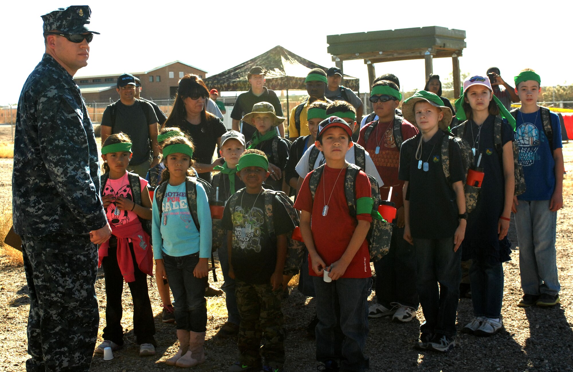 Children stand in formation with their "drill instructor" during the "Boot On Boots Off" event on Davis-Monthan Air Force Base, Ariz., Dec. 10, 2012. The mock deployment environment, designed to help kids understand what their parents experience while deployed, featured a processing line, medical tent and obstacle course.