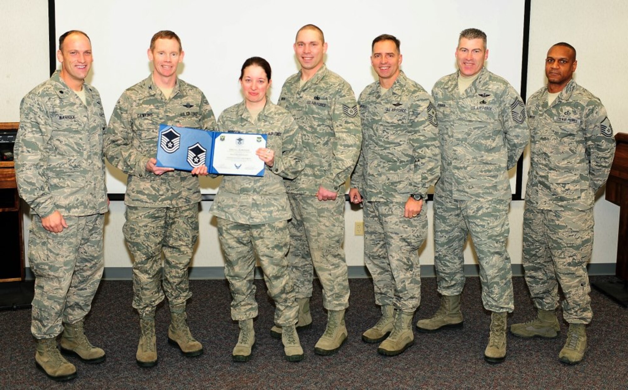 Congratulations to Master Sgt. Erica Robinson, 5th Operations Support Squadron, on her recent STEP promotion. Robinson is shown accepting her new stripe from Col. James Dawkins, 5th Bomb Wing commander. (U.S. Air Force photo/ Airman 1st Class  Kristoffer Kaubisch)
