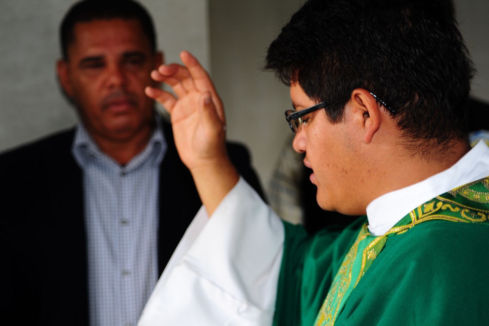 A priest blesses a home during the ribbon cutting ceremony November 28, 2012 for 61 new homes in the community of Cane as the Mayor of Cane, Jose Rosario Tejeda, looks on. More than 100 servicemembers volunteered time to build 14 houses in the community of Cane, Honduras near Soto Cano Air Base.U.S. Air Force photo/Capt. Rebecca Heyse)