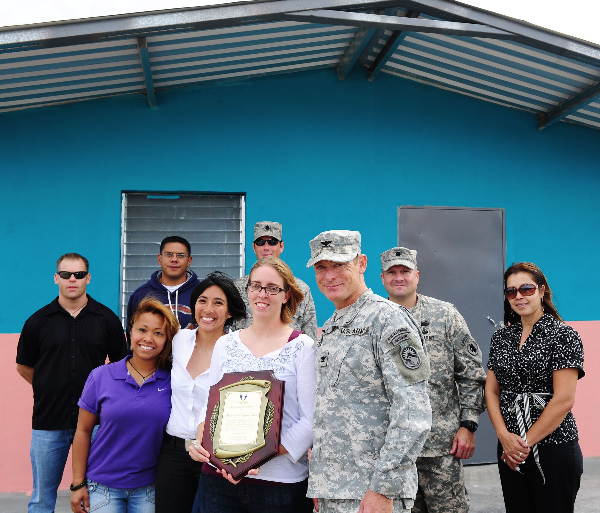 Representatives from Joint Task Force-Bravo pause for a photo in front of one of the houses they helped construct over five weeks after the ribbon cutting ceremony November 28, 2012. More than 100 servicemembers volunteered time to build 14 houses in the community of Cane, Honduras near Soto Cano Air Base.(U.S. Air Force photo/Capt. Rebecca Heyse)