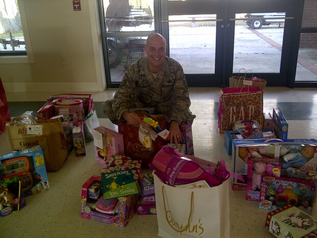 Master Sgt. Brent Hopkins, 437th Operations Support Squadron first sergeant, displays the gifts donated to the Joint Base Charleston Angel Tree program  Dec. 14, 2012 at the Chapel Annex at JB Charleston – Air Base, S.C. The program raised more than 300 gifts for military children whose families may be facing financial hardships this holiday season. (Courtesy photo)