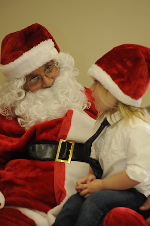 Levi Douglass, 2-year-old son of Tech. Sgt. Frank Douglass, 437th Aerial Port Squadron,  visits with Santa Clause Dec. 15, 2012, during the third Annual Deployed Children’s Holiday Party hosted by the Team Charleston Honorary Commander’s Advisory Council at Joint Base Charleston – Air Base, S.C.  (U.S. Air Force photo/ Master Sgt. Maria Bare)