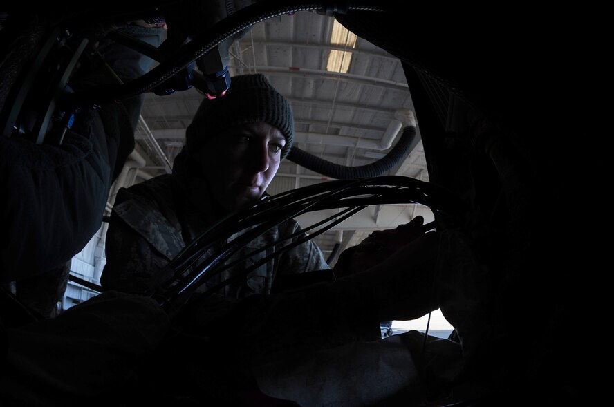 Airman 1st Class Tylher Whaley, 9th Aircraft Maintenance Squadron crew chief, works inside an Air Force RQ-4 Global Hawk intelligence, surveillance and reconnaissance aircraft Dec. 19, 2012, at Beale Air Force Base, Calif. Crew chiefs re-assembled the aircraft after it underwent maintenance. (U.S. Air Force photo by Senior Airman Shawn Nickel/Released)