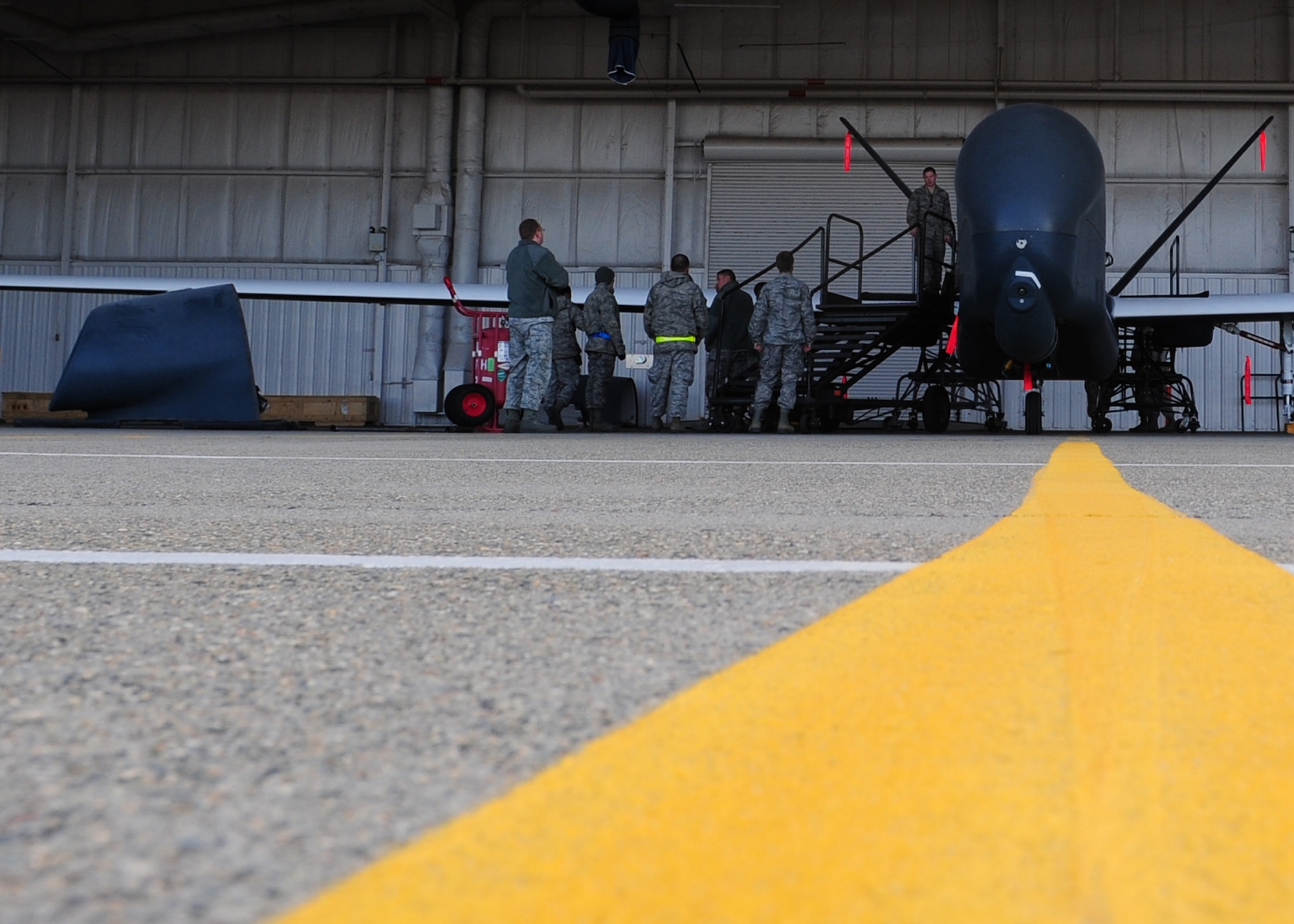 Airmen from the 9th Aircraft Maintenance Squadron prepare to place the forward nacelle air intake on an Air Force RQ-4 Global Hawk intelligence, surveillance and reconnaissance aircraft Dec. 19, 2012, at Beale Air Force Base, Calif. The part was repaired off the aircraft to ensure no dust or debris damaged internal parts. (U.S. Air Force photo by Senior Airman Shawn Nickel/Released)