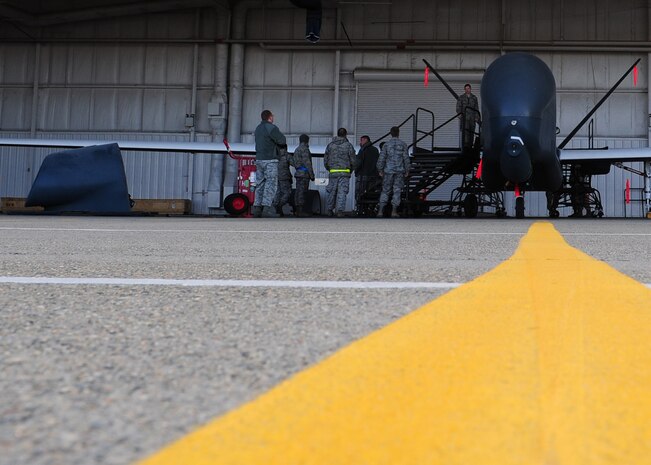 Airmen from the 9th Aircraft Maintenance Squadron prepare to place the forward nacelle air intake on an Air Force RQ-4 Global Hawk intelligence, surveillance and reconnaissance aircraft Dec. 19, 2012, at Beale Air Force Base, Calif. The part was repaired off the aircraft to ensure no dust or debris damaged internal parts. (U.S. Air Force photo by Senior Airman Shawn Nickel/Released)
