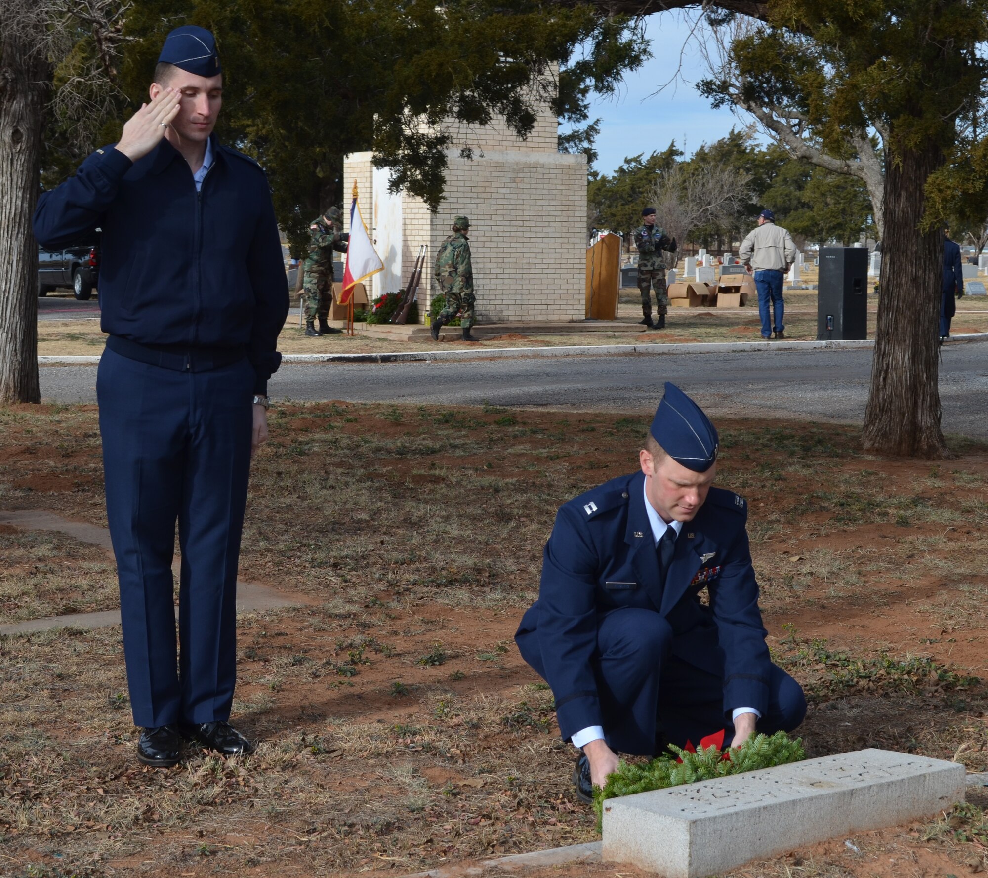 Capt Ryan Yingling lays a wreath while 2Lt Scott Neidrick salutes during a wreath laying ceremony on Dec. 15 at the Eastview Cemetery in Vernon, Tx. The event was part of "Wreaths Across America Ceremony," a national campaign to honor those who serve and remember the fallen heroes. (Courtesy Photo). 