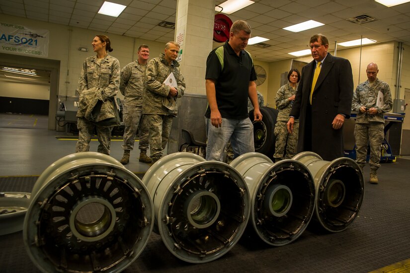 John Speaks, 437th Maintenance Squadron work lead, displays wheels   to the Terry Yonkers, Assistant to the Secretary of the Air Force for Installations, Environment and Logistics, during a tour Dec. 13, 2012, at Joint Base Charleston - Air Base, S.C. Yonkers spoke with Airmen about innovation and ways they could improve the Air Force. Yonkers is responsible for providing oversight for all matters pertaining to the formulation, review, and execution of plans, policies, programs, and budgets for installations, energy, environment, safety and occupational health as well as weapon systems logistics support. (U.S. Air Force photo/ Airman 1st Class George Goslin) 