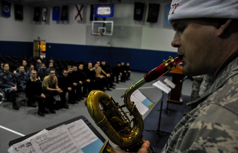 Tech. Sgt. Jeffery Saunders, The U.S. Air Force Heritage Ramblers Dixieland Ensemble’s baritone saxophone player, plays the song “Let it Snow’ Dec. 13,  2012, at Joint Base Charleston – Weapons Station, S.C. Six members from the USAF Heritage Ramblers from Joint Base Langley – Eustis, Va., performed holiday carols at several commands on the Air Base and Weapons Station. The USAF Heritage Ramblers, a part of the Heritage of America Band, was formed in 2010. The group's mission is to preserve and present the rich heritage of traditional jazz. With the music of such legends as Louis Armstrong, Sidney Bechet, Jack Teagarden, and Bix Beiderbecke as their guide, Heritage Ramblers bring the New Orleans and Chicago styles of traditional jazz to life in each performance.  (U.S. Air Force photo/ Airman 1st Class Jared Trimarchi)