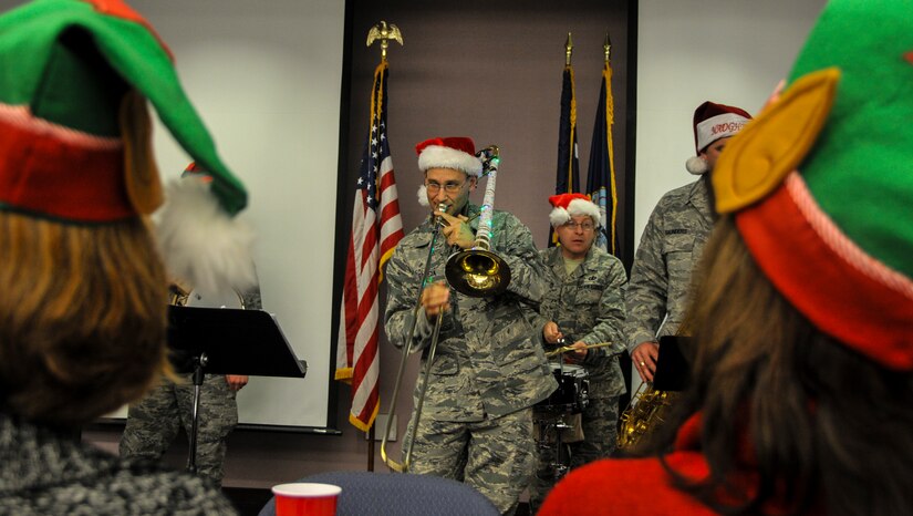 Tech. Sgt. John Garcia, U.S. Air Force Heritage Ramblers Dixieland Ensemble’s trombone player, performs in front of more than 150 Space and Naval Warfare Systems Command  members Dec. 13, 2012, at  Joint Base Charleston – Weapons Station, S.C. Six members from the USAF Heritage Ramblers from Joint Base Langley – Eustis, Va., performed holiday carols at several commands on the Air Base and Weapons Station. The USAF Heritage Ramblers, a part of the Heritage of America Band, was formed in 2010. The group's mission is to preserve and present the rich heritage of traditional jazz. With the music of such legends as Louis Armstrong, Sidney Bechet, Jack Teagarden, and Bix Beiderbecke as their guide, Heritage Ramblers bring the New Orleans and Chicago styles of traditional jazz to life in each performance. (U.S. Air Force photo/ Airman 1st Class Jared Trimarchi) 