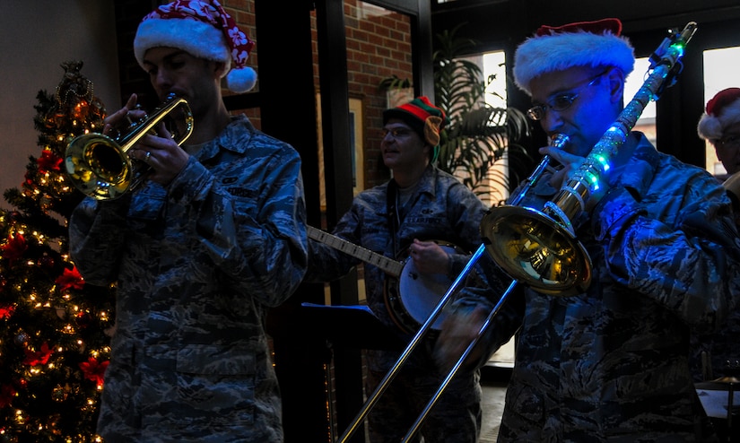 Members of the U.S. Air Force Heritage Ramblers Dixieland Ensemble from Joint Base Langley – Eustis, Va., play holiday music Dec. 13, 2012, at the 437 th Operations Group headquarters on Joint Base Charleston – Air Base, S.C   Six members from the USAF Heritage Ramblers performed holiday carols at several commands on the Air Base and Weapons Station. The USAF Heritage Ramblers, a part of the Heritage of America Band, was formed in 2010. The group's mission is to preserve and present the rich heritage of traditional jazz. With the music of such legends as Louis Armstrong, Sidney Bechet, Jack Teagarden, and Bix Beiderbecke as their guide, Heritage Ramblers bring the New Orleans and Chicago styles of traditional jazz to life in each performance. (U.S. Air Force photo/ Airman 1st Class Jared Trimarchi)