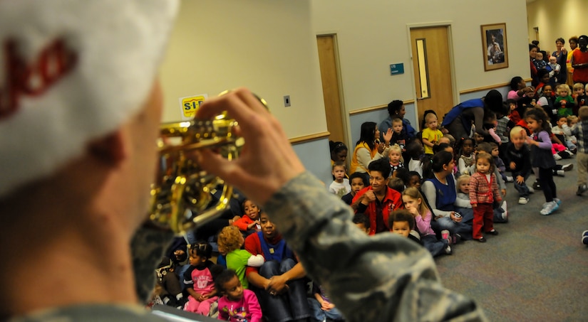 Staff Sgt. James Lantz, U.S. Air Force Heritage Ramblers Dixieland Ensemble’s cornet player, performs for more than 250 children Dec. 13, 2012, at the Child Development Center on Joint  Base Charleston – Air Base, S.C. Six members from the USAF Heritage Ramblers from Joint Base Langley – Eustis, Va., performed holiday carols at several commands on the Air Base and Weapons Station. The USAF Heritage Ramblers, a part of the Heritage of America Band, was formed in 2010. The group's mission is to preserve and present the rich heritage of traditional jazz. With the music of such legends as Louis Armstrong, Sidney Bechet, Jack Teagarden, and Bix Beiderbecke as their guide, Heritage Ramblers bring the New Orleans and Chicago styles of traditional jazz to life in each performance.  (U.S. Air Force photo/ Airman 1st Class Jared Trimarchi)