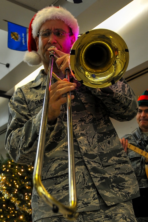 Tech. Sgt. John Garcia, U.S. Air Force Heritage Ramblers Dixieland Ensemble’s trombone player, performs a solo Dec. 13, 2012, at the passenger terminal on Joint Base Charleston – Air Base , S.C. Six members from the USAF Heritage Ramblers from Joint Base Langley – Eustis, Va., performed holiday carols at several commands on the Air Base and Weapons Station. The USAF Heritage Ramblers, a part of the Heritage of America Band, was formed in 2010. The group's mission is to preserve and present the rich heritage of traditional jazz. With the music of such legends as Louis Armstrong, Sidney Bechet, Jack Teagarden, and Bix Beiderbecke as their guide, Heritage Ramblers bring the New Orleans and Chicago styles of traditional jazz to life in each performance. (U.S. Air Force photo/ Airman 1st Class Jared Trimarchi) 