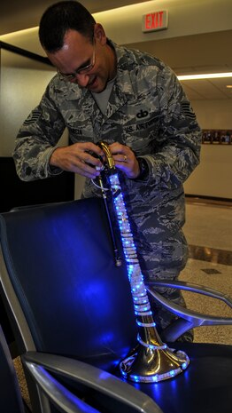 Tech. Sgt. John Garcia, United States Air Force Heritage Ramblers Dixieland Ensemble’s trombone player, powers up the lights on his instrument Dec. 13, 2012, at the passenger terminal on Joint Base Charleston – Air Base, S.C.  Six members from the USAF Heritage Ramblers from Joint Base Langley – Eustis, Va., performed holiday carols at several commands on the Air Base and Weapons Station. The USAF Heritage Ramblers, a part of the Heritage of America Band, was formed in 2010. The group's mission is to preserve and present the rich heritage of traditional jazz. With the music of such legends as Louis Armstrong, Sidney Bechet, Jack Teagarden, and Bix Beiderbecke as their guide, Heritage Ramblers bring the New Orleans and Chicago styles of traditional jazz to life in each performance. (U.S. Air Force photo/ Airman 1st Class Jared Trimarchi) 