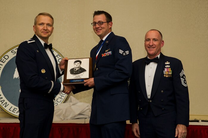 Col. Darren Hartford (left), 437th Airlift Wing commander, and Chief Master Sgt. Earl Hannon, 628th Air Base Wing command chief, present Senior Airman Joshua Nelson, 15th Airlift Squadron, the John Levitow Award during the Airman Leadership School Class 13–A graduation ceremony Dec. 13, 2012,  at JB Charleston - Air Base, S.C. The Levitow Award is awarded for a student's exemplary demonstration of excellence, both as a leader and scholar. (U.S. Air Force photo/Airman 1st Class George Goslin)