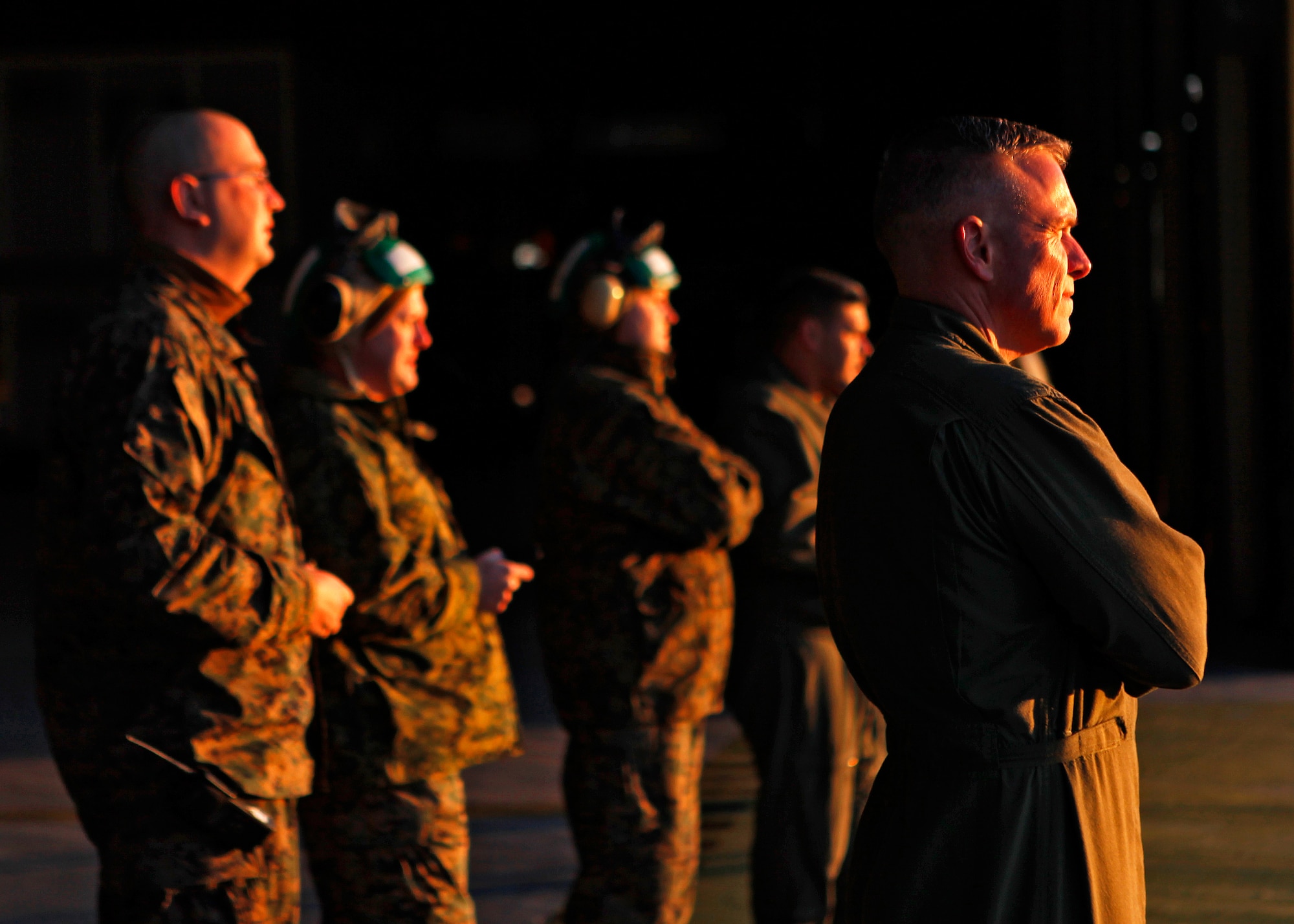 Marines from the Marine Aircraft Group 41, Detachment Alpha, and the Marine Medium Helicopter Squadron 764 look on as the sun rises over the squadron's last CH-46 as it departs the Edwards Air Force Base flightline for the last time Dec. 19, 2012. The CH-46 Sea Knight helicopter, tail number 5310, will be flown and processed into storage at Davis-Monthan Air Force Base, Ariz. (U.S. Air Force photo by Jet Fabara)