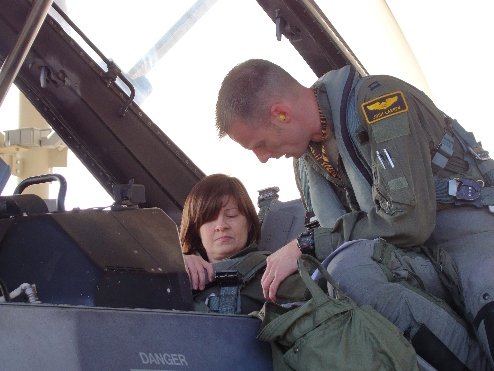 Amy Butler, a senior editor for “Aviation Week & Space Technology,” connects various fasteners in the back seat of an F-16D Fighting Falcon as Capt. Josh Larsen, a 79th Fighter Squadron pilot, talks her through the pre-flight process, at Shaw Air Force Base, S.C., Nov. 28, 2012. Butler visited the 20th Fighter Wing for her first flight in an Air Force fighter aircraft as she gathered information about the F-16 for stories. (U.S. Air Force photo by Rob Sexton/Released)