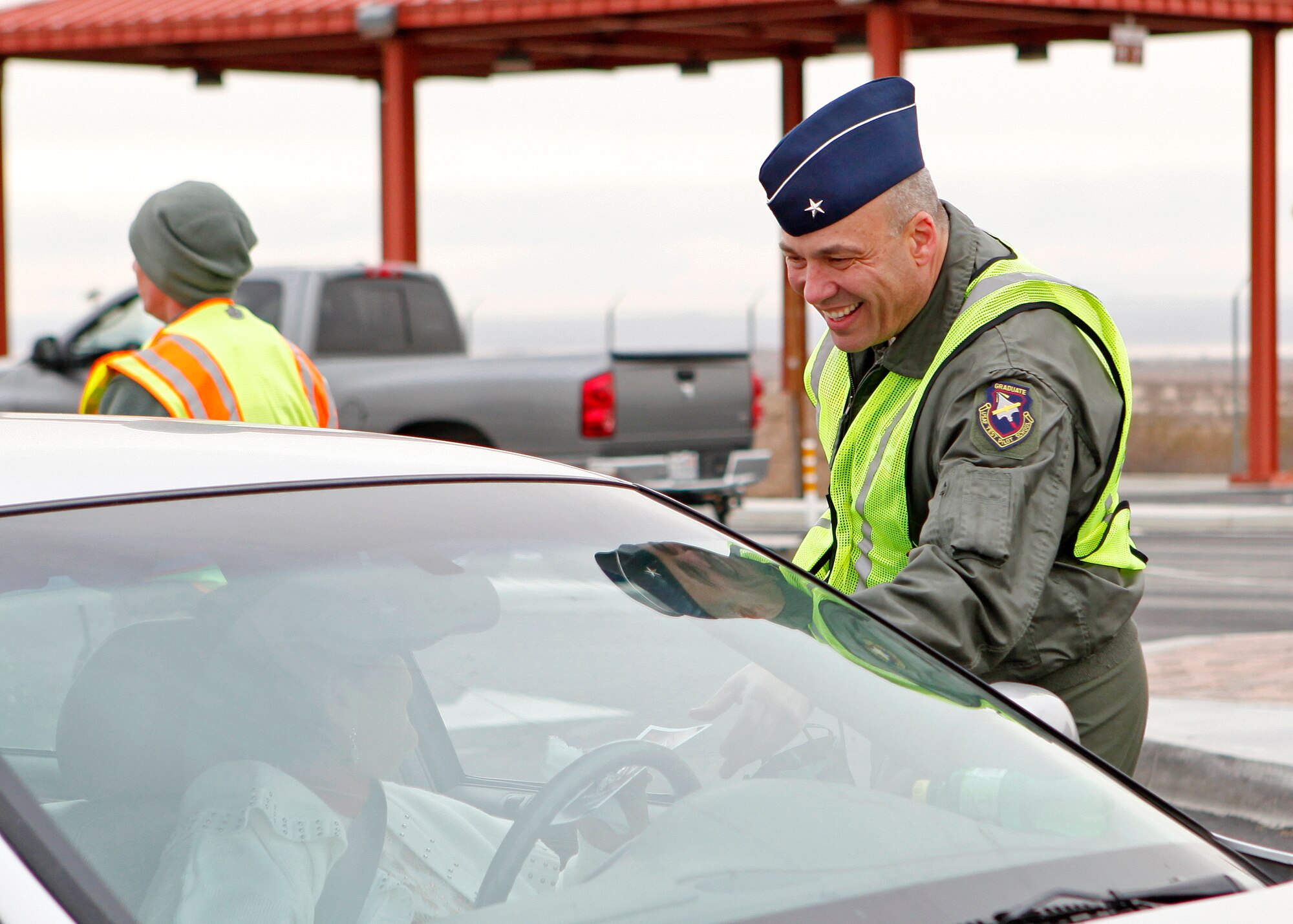 Brig. Gen. Michael Brewer, 412th Test Wing commander, was on hand to greet members from the Edwards community as they depart for the holiday season during the annual holiday safety gate greeting Dec. 14 at the West Gate exit. The annual safety gate greeting serves as a way of base leadership expressing their concern over Team Edwards staying safe and stress-free during the holiday season. (U.S. Air Force photo by Jet Fabara)