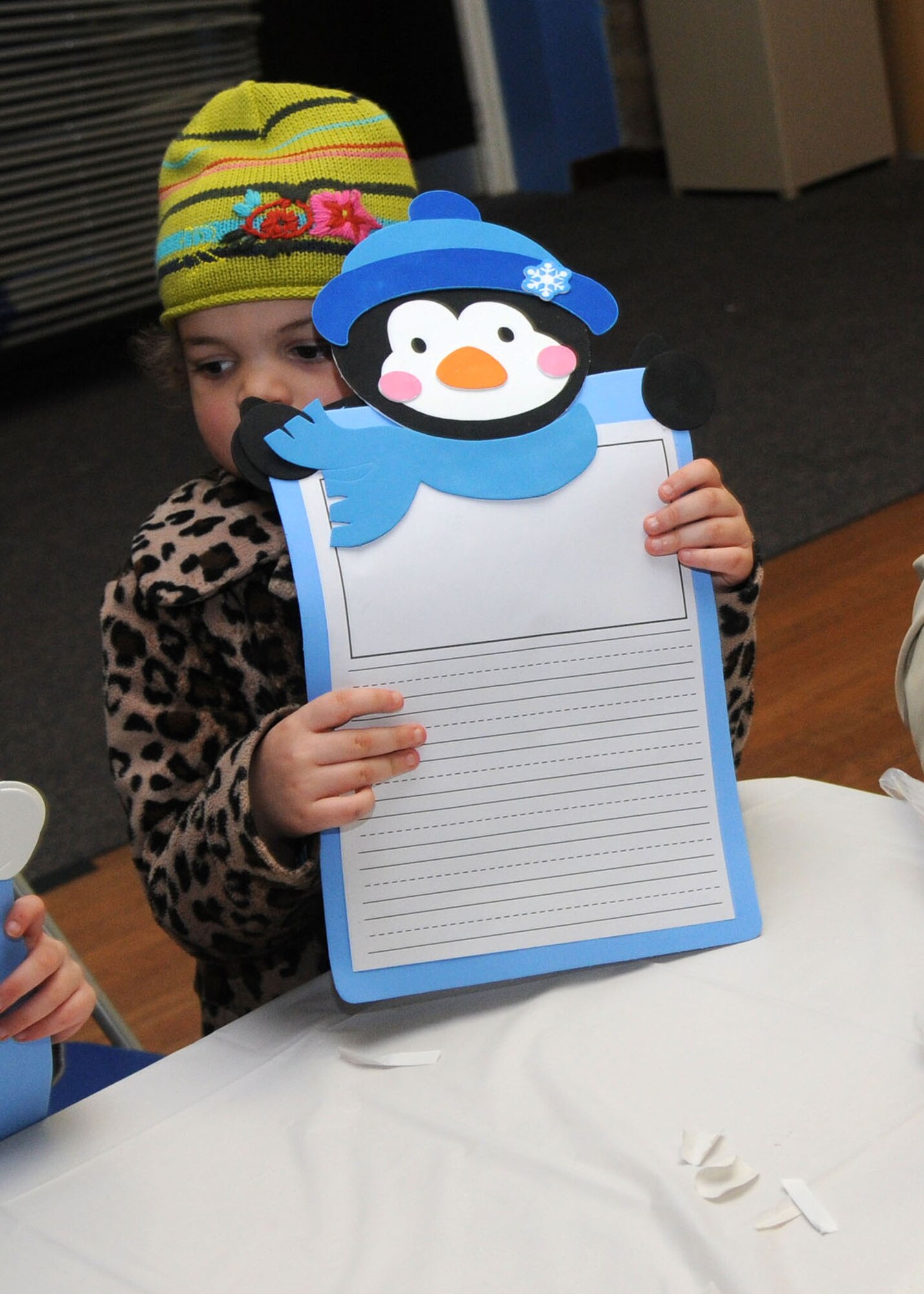 Amelia King, 5, daughter of Tech. Sgt. Keegan King, from 100th Logistics Readiness Squadron supply section, holds up a winter story craft Dec. 18, 2012, at the Bob Hope Community Center at RAF Mildenhall, England. Hosted by the community center, the event gave families the chance to make some holiday-themed ornaments and crafts. (U.S. Air Force photo by Airman 1st Class Kelsey Waters/Released)