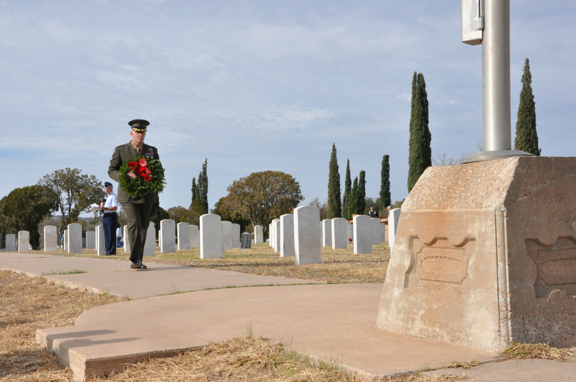 SAN ANGELO, Texas – Marine Corps Maj. Douglas March, Marine Corps Detachment Commanding Officer, walks to the base of the flagpole at the Belvedere Cemetery Dec. 15. Members from each branch of the military placed wreaths at the base of the flagpole to honor service members who passed away. (U.S. Air Force photo/ 1st Lt. Leanne Hedgepeth)
