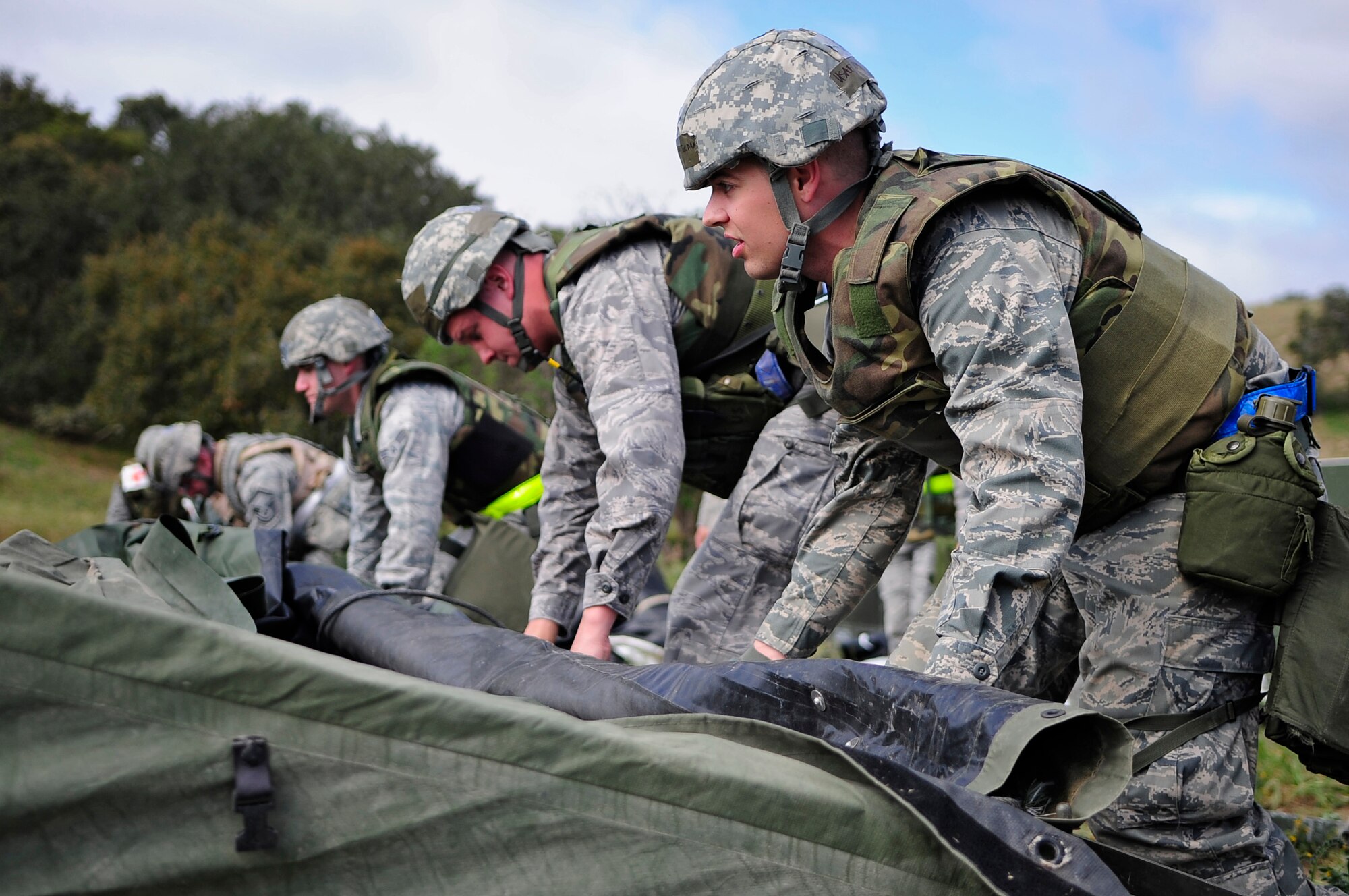 VANDENBERG AIR FORCE BASE, Calif. -- Team V members line up and prepare to raise a medical tent here Thursday, March 15, 2012. The Northstar exercise tests the deployment capabilities and combat readiness skills for Vandenberg Airmen. (U.S. Air Force photo/Michael Peterson)