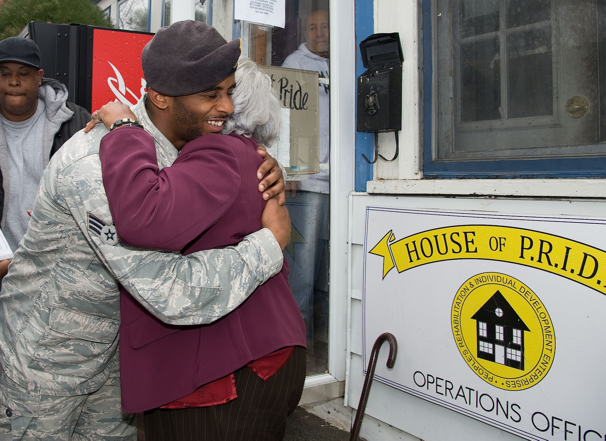 SrA Deandre Harrington (left) of the 436th Security Forces Squadron, Dover Air Force Base, Del. shares a hug with Marian Harris, Executive Director of the  Operation Pride homeless shelter on Dec. 10, 2012. Harrington and other airman from the base delivered food and clothing items gathered for the needy. (U.S. Air Force photo by Greg L. Davis)
