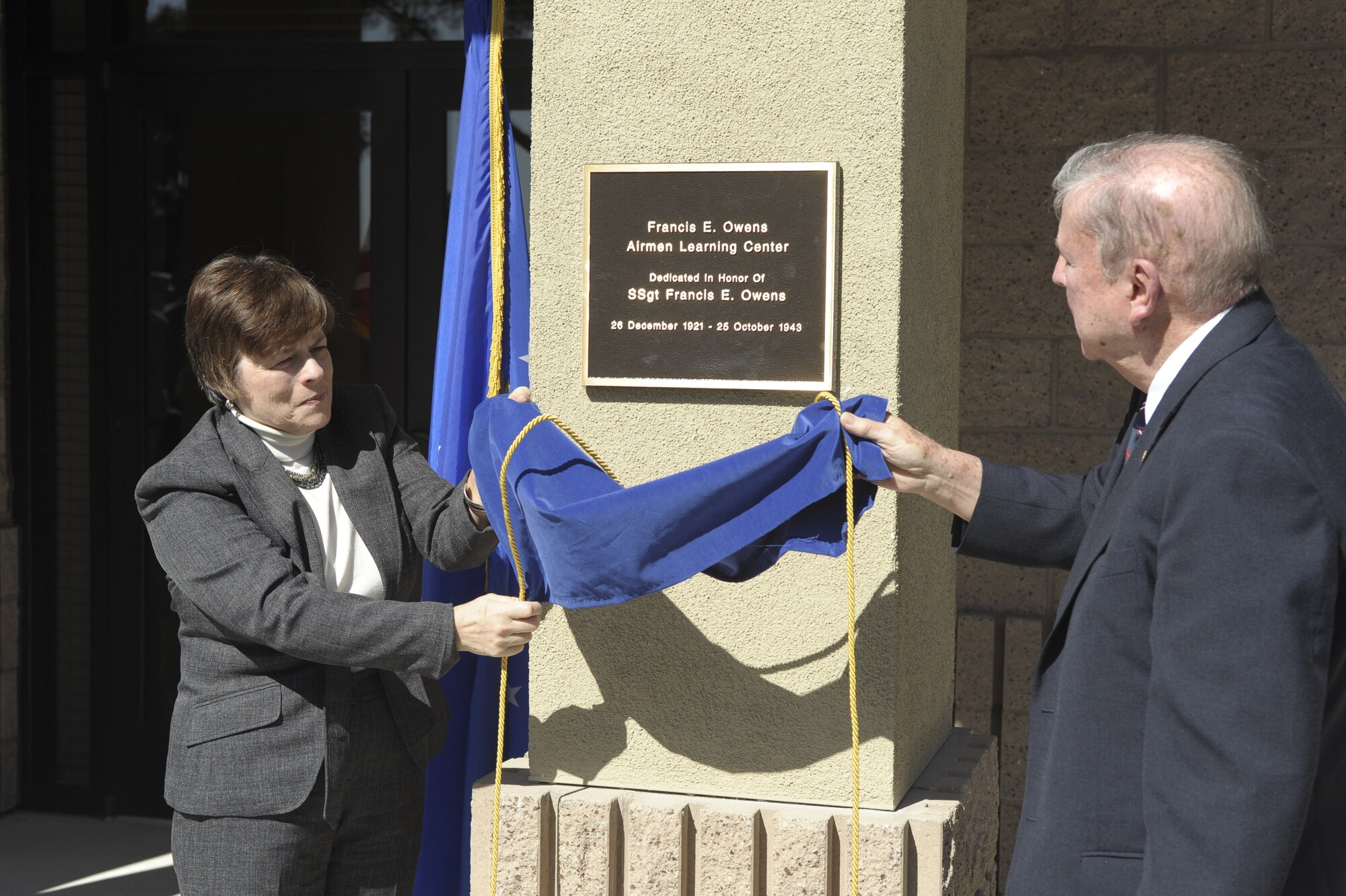 VANDENBERG AIR FORCE BASE, Calif. -- Janice Schoeneberger, the niece of Staff Sgt. Francis Owens, and James Owens the brother of Staff Sgt. Francis Owens, World War II Army Air Corps 533rd Bombardment Squadron B-17 Bomber tail gunner, unveil a plaque during the 381st Training Group Airman Learning Center building dedication Friday, March 9, 2012. Staff Sgt. Owens died in support of WWII during an escape from enemy personnel in Belgium. (U.S. Air Force photo/Staff Sgt. Andrew Satran) 