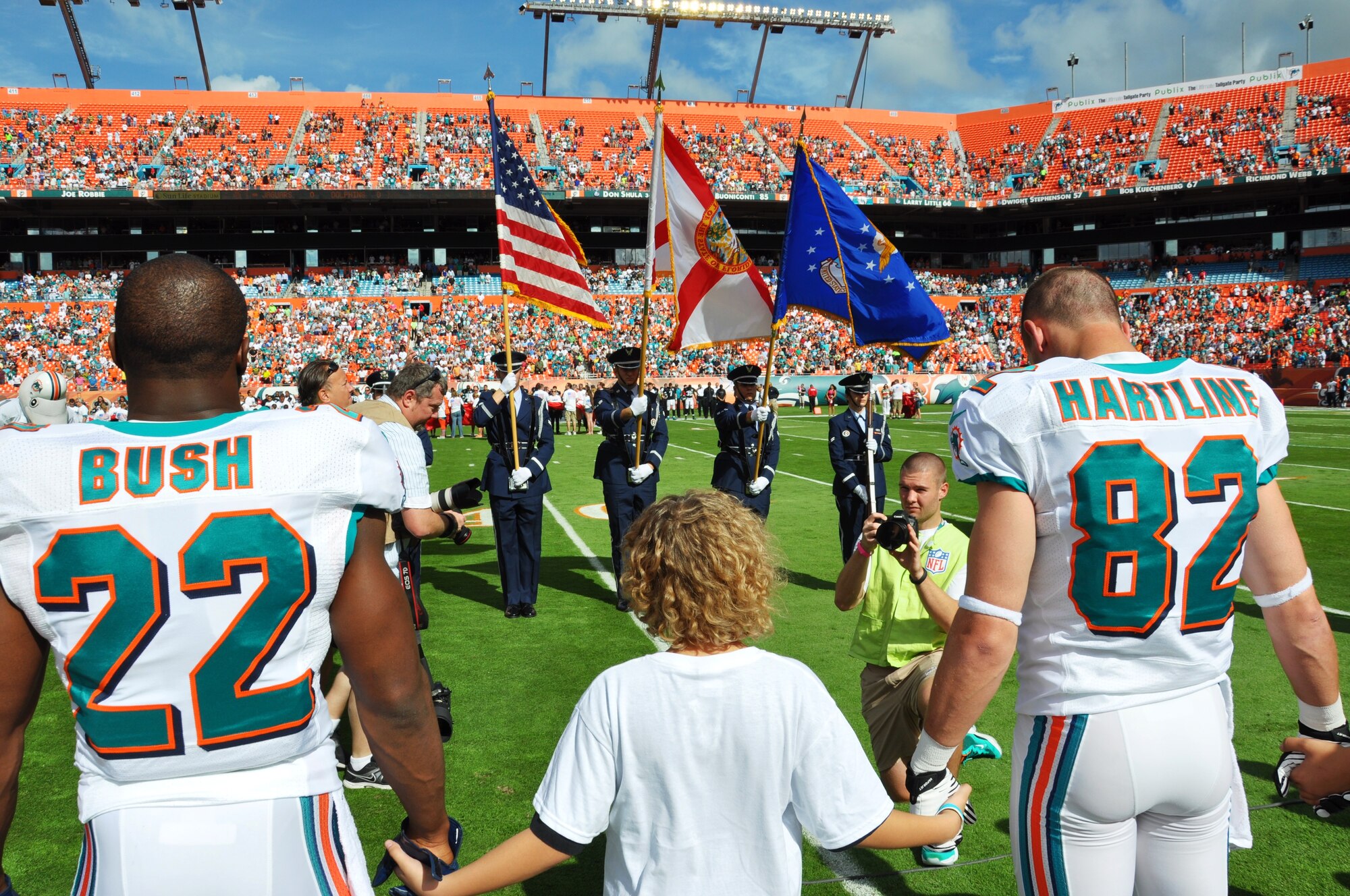 While the colors were being rendered by the 45th Space Wing Honor Guard
during the game, children from the community held hands with Miami Dolphin's
football players for a moment of silence in remembrance of the victims from
the Newtown shooting in Connecticut.

(Photo by: 2nd Lt. Alicia Wallace)