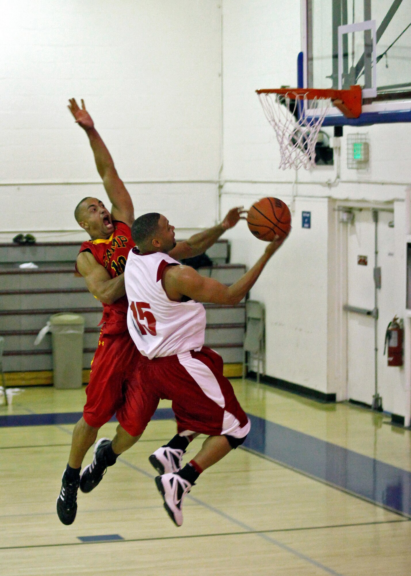 Sidney Melvin (#15), Edwards Air Force Base small forward, goes up for a layup before being fouled by a defender from the Camp Pendleton men's basketball team on Dec. 16 at the Rosburg Fitness Center. The men's varsity team finished the two-day event with a 3-0 record. (U.S. Air Force photo by Jet Fabara)