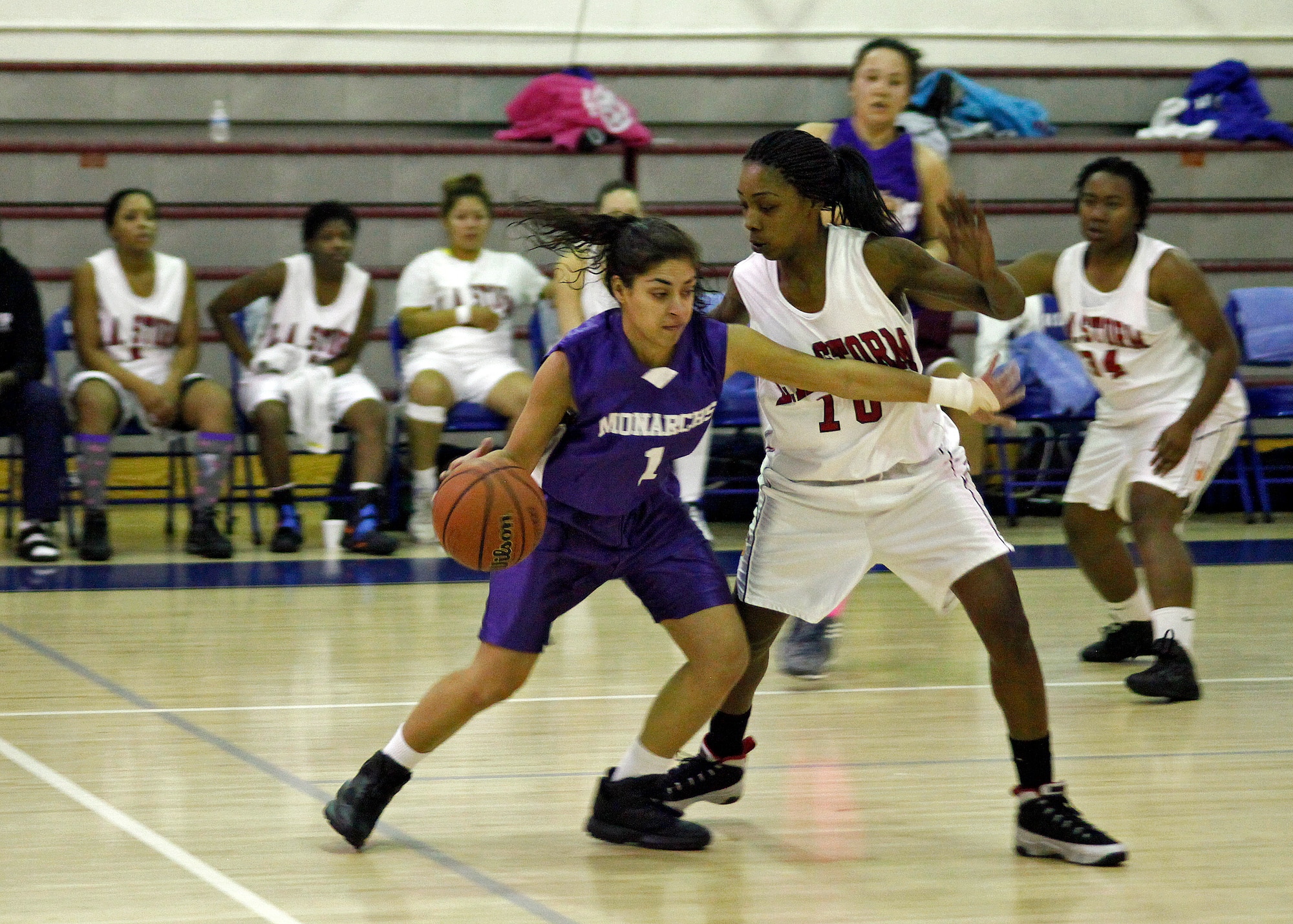 Diane Fernandes (#1), Edwards Air Force Base point guard, attempts to drive past a defender from the L.A. Storm woman's varsity basketball team on Dec. 16 at the Rosburg Fitness Center. The Edwards Air Force Base women's varsity basketball team played against teams from Los Angeles, Calif., Las Vegas, Nev., and Marine Corps Air Station Camp Pendleton, Calif. (U.S. Air Force photo by Jet Fabara)